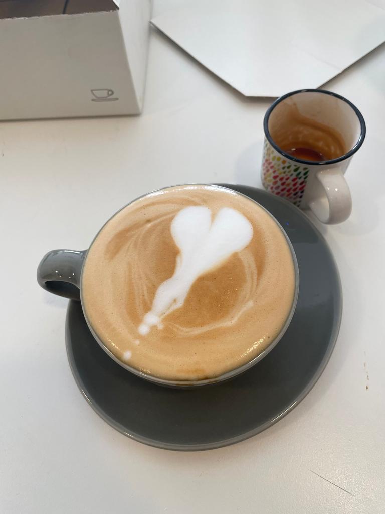 a picture of a latte with very poorly made latte art
